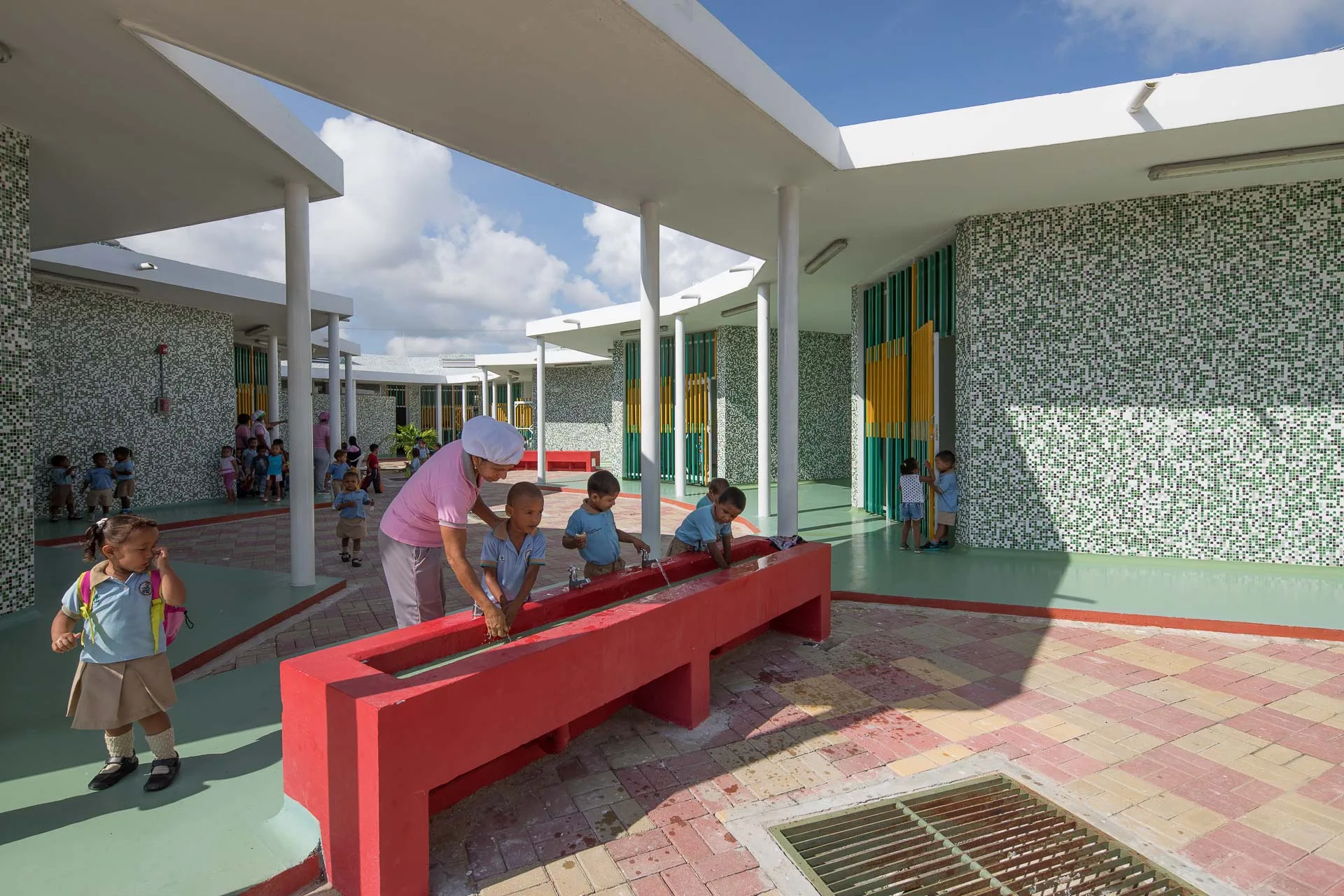 Niños jugando en las zonas verdes y patios centrales del conjunto de preescolares.